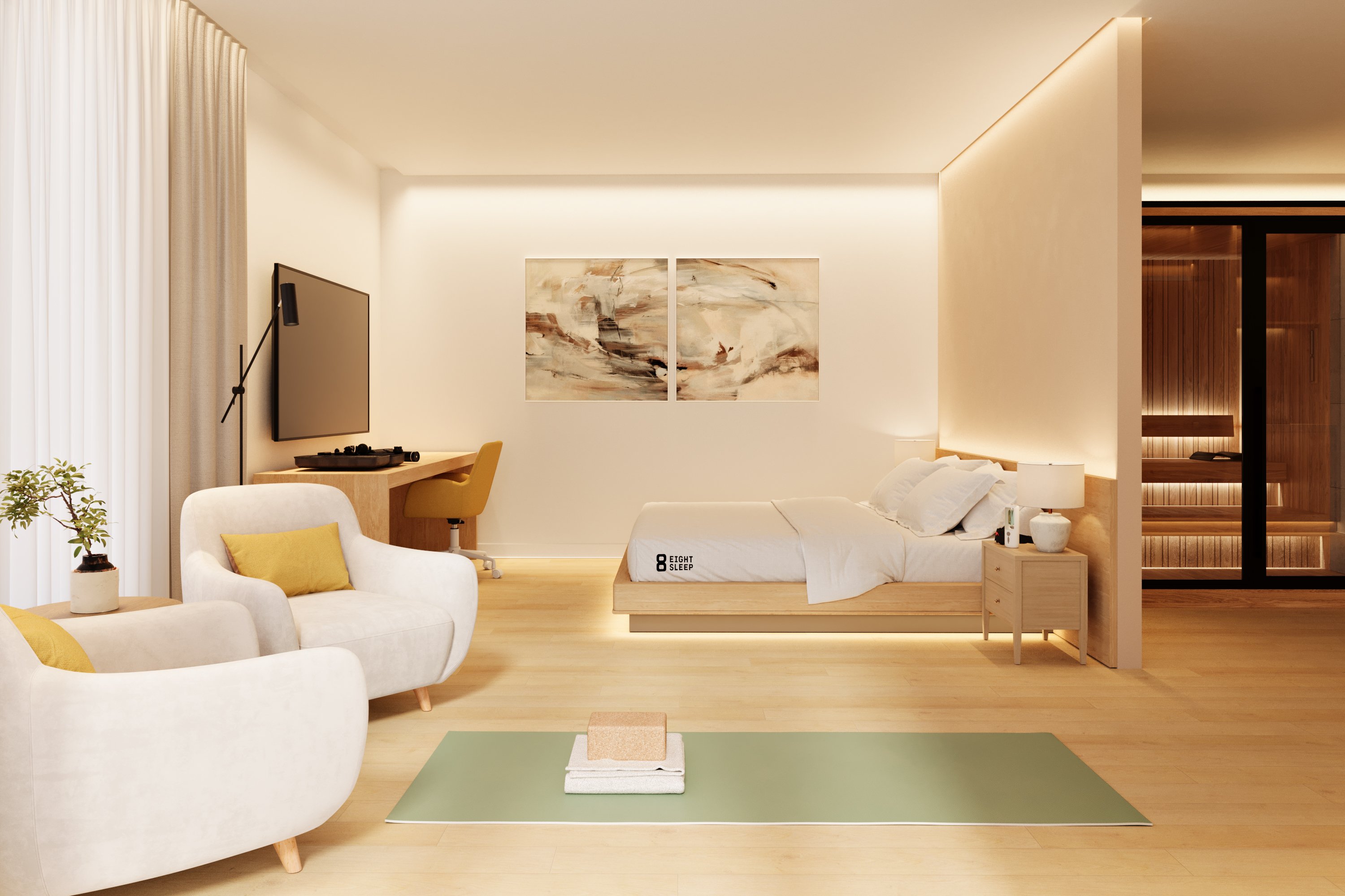 A guest room with a bed, lounge chairs, work desk, yoga mat and warm sauna glow beyond