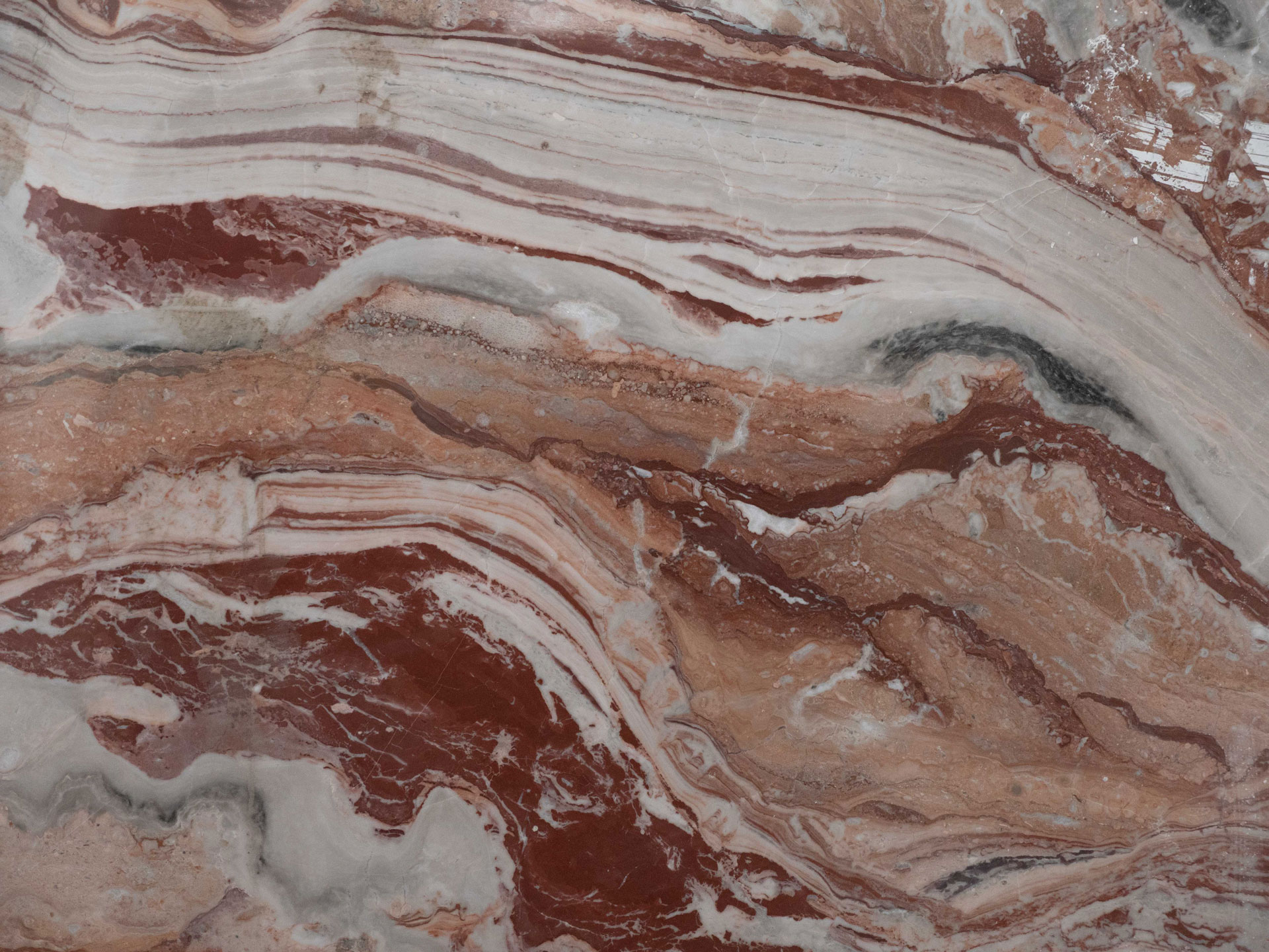 Arabescato Orobico Rosso with flowing red, ochre, white and grey natural veining