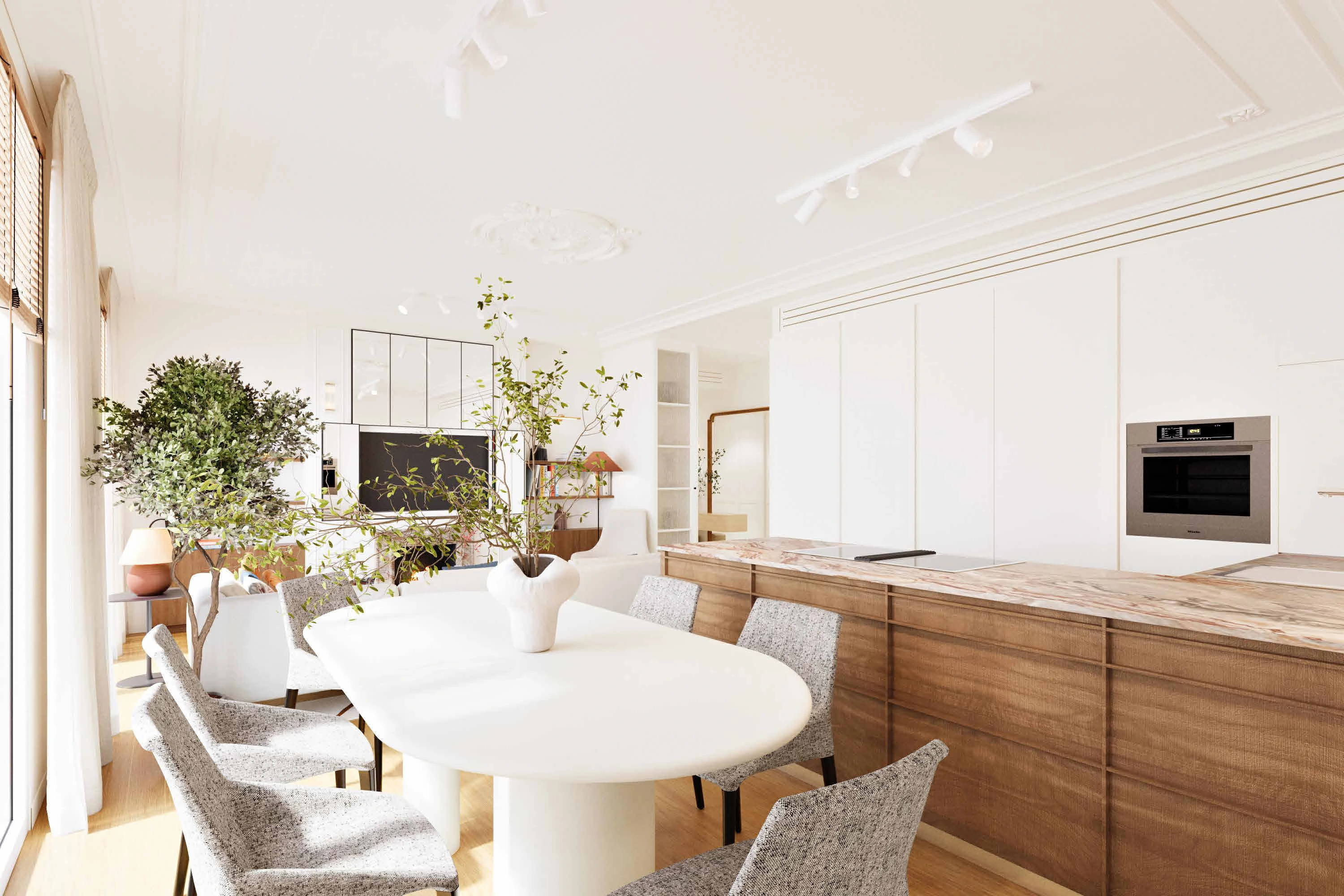 The dining table, oak kitchen joinery and pale stone worktop