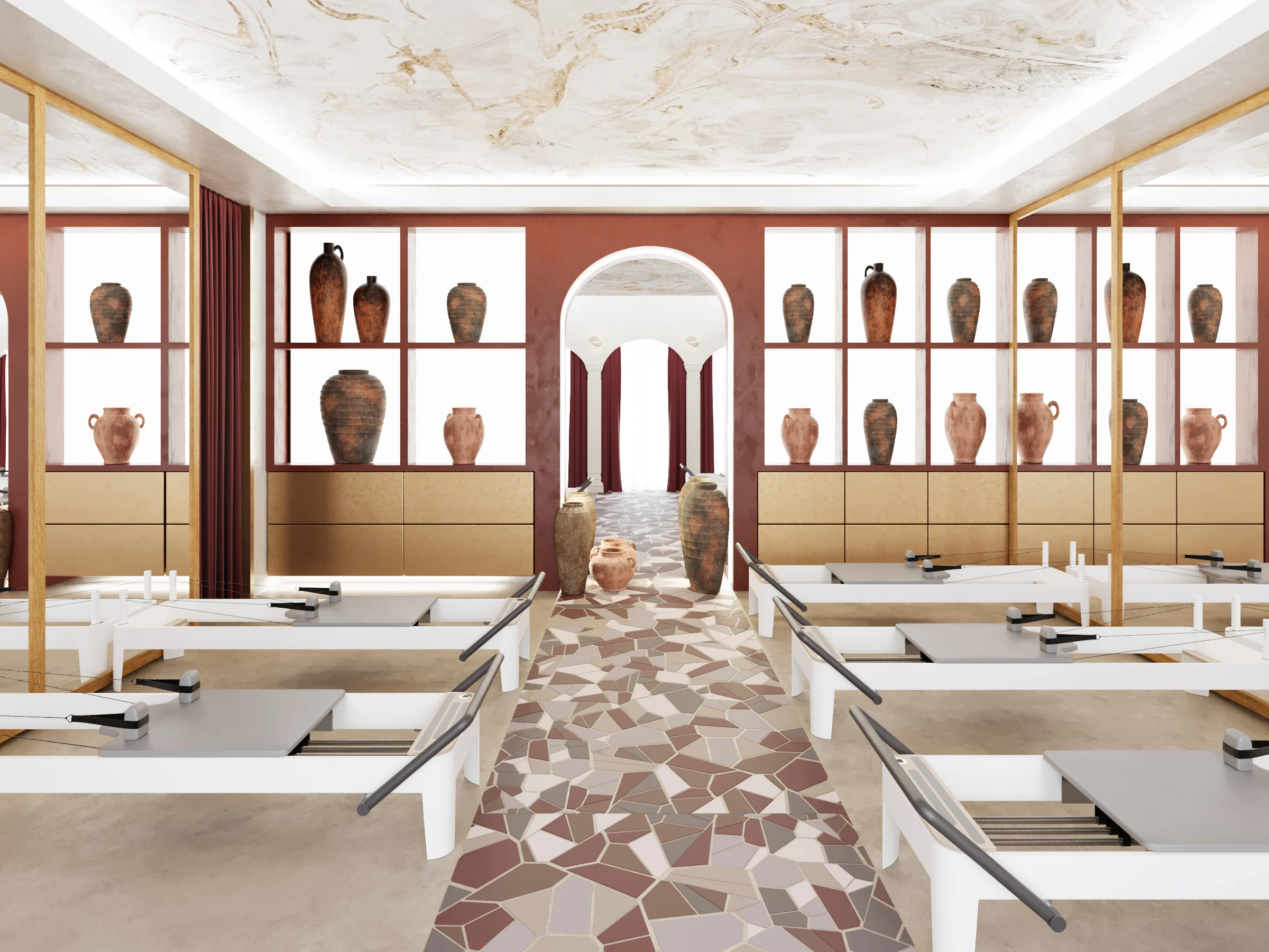 Training room with reformer beds, arched doorway, burgundy curtains and patterned broken tile path